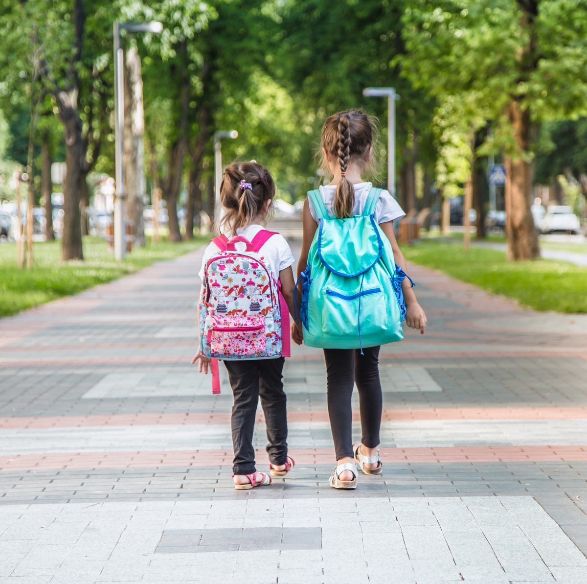 Children carrying backpacks on the way to class abroad