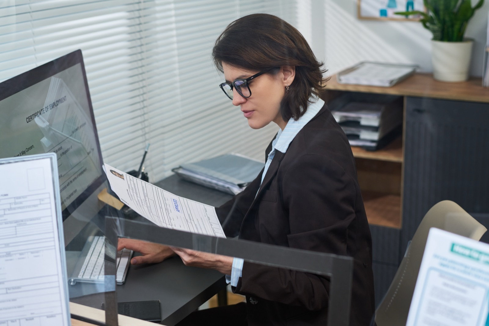 Consultant reviewing police clearance paperwork at a service desk